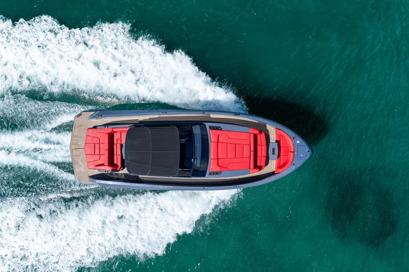 Slide: The Image of Aerial view of 2021 Vanquish Yachts 45 cruising on turquoise water. - 5