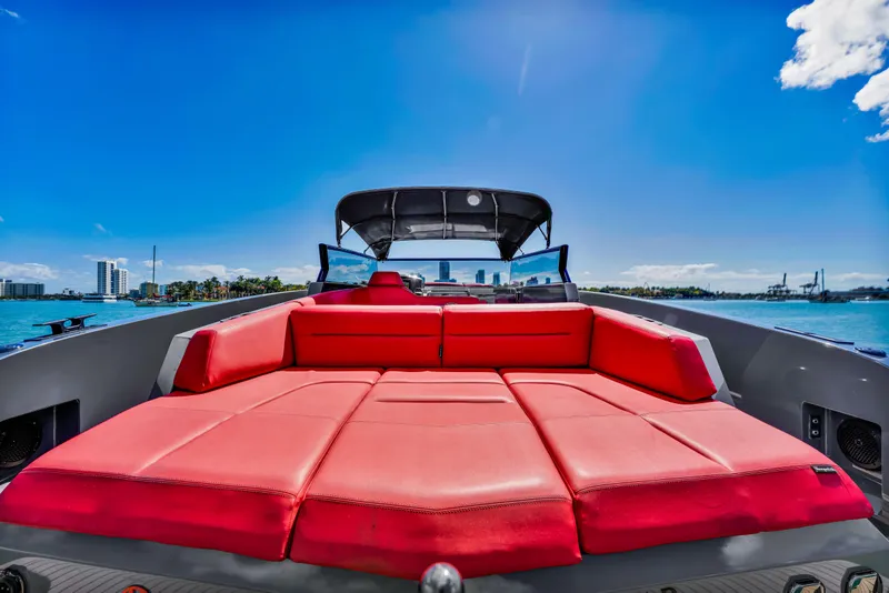 Slide: The Image of Luxurious 2021 Vanquish Yachts 45 with vibrant red seating, set against a clear blue sky. - 51