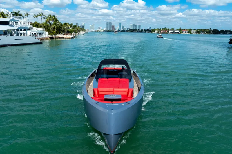 Slide: The Image of 2021 Vanquish Yachts 45 cruising on a sunny day with city skyline backdrop. - 8