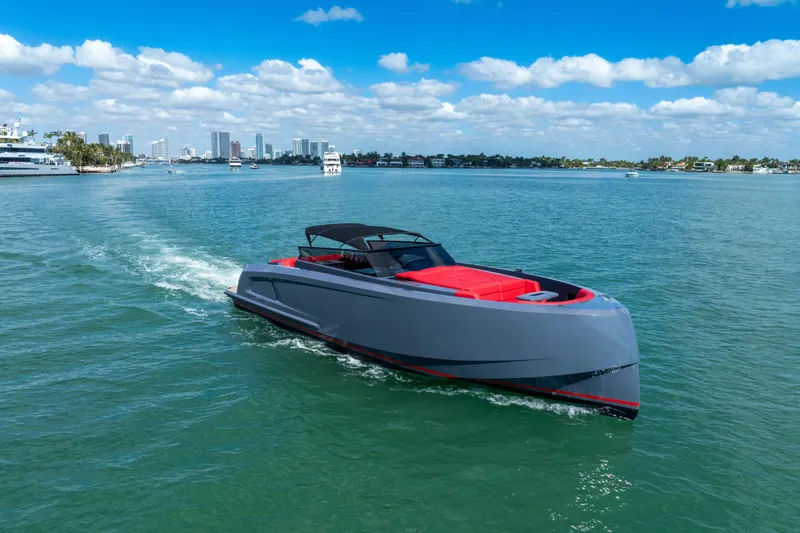 Slide: The Image of 2021 Vanquish Yachts 45 cruising on a sunny day with city skyline in background. - 9