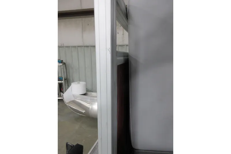 Slide: The Image of 2026 Sun Tracker SportFish 22 DLX interior detail with aluminum and upholstery elements. - 12