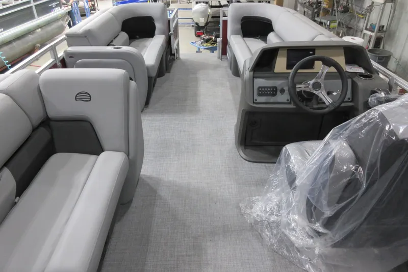 Slide: The Image of 2026 Sun Tracker SportFish 22 DLX pontoon boat interior with plush seating and modern helm. - 2