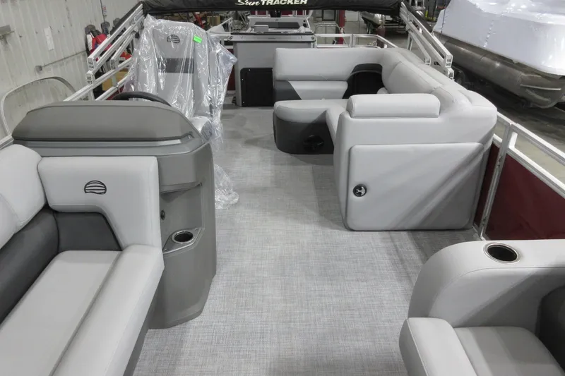 Slide: The Image of 2026 Sun Tracker SportFish 22 DLX pontoon boat interior with gray seating and modern design. - 6