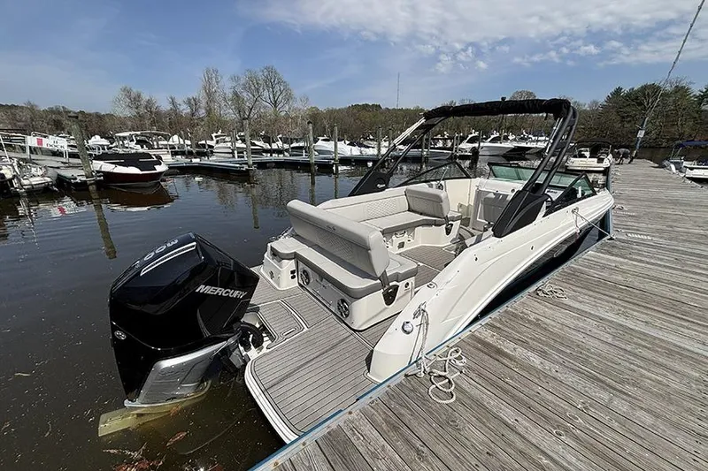 Slide: The Image of 2024 Sea Ray SDX 250 Outboard boat docked at a marina, showcasing sleek design and powerful engine. - 1