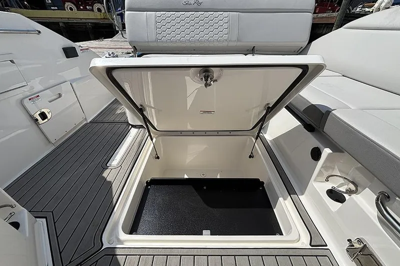 Slide: The Image of 2024 Sea Ray SDX 250 Outboard boat storage compartment open, showcasing spacious interior. - 10