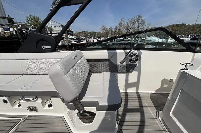 Slide: The Image of 2024 Sea Ray SDX 250 Outboard interior with gray seating and modern design. - 15