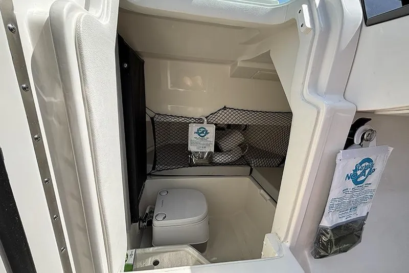 Slide: The Image of 2024 Sea Ray SDX 250 Outboard boat interior with compact bathroom amenities. - 17