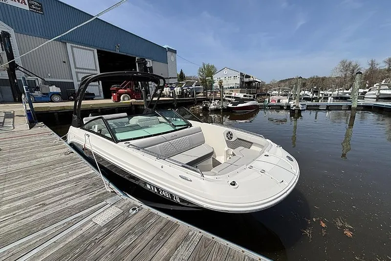 Slide: The Image of 2024 Sea Ray SDX 250 Outboard docked at a marina, ready for boating. - 2