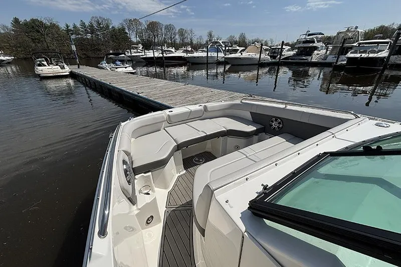 Slide: The Image of 2024 Sea Ray SDX 250 Outboard boat docked at marina with spacious seating. - 20