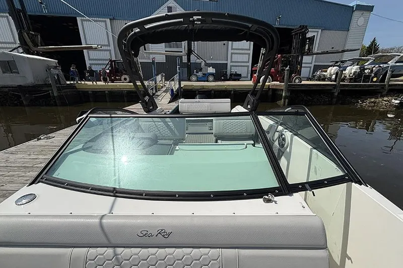 Slide: The Image of 2024 Sea Ray SDX 250 Outboard boat docked, showcasing sleek design and spacious interior. - 26