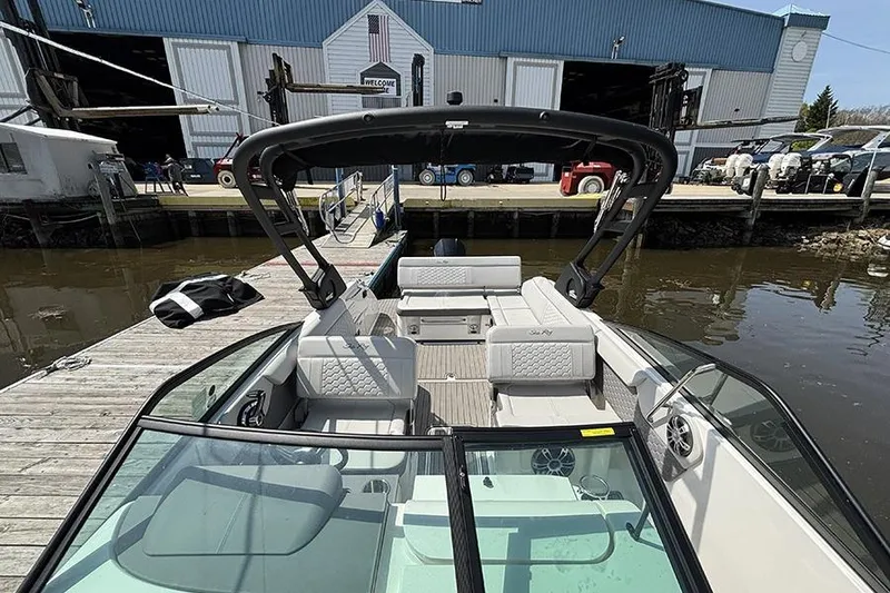 Slide: The Image of 2024 Sea Ray SDX 250 Outboard boat docked, showcasing spacious seating and sleek design. - 27