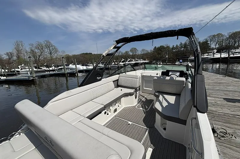 Slide: The Image of 2024 Sea Ray SDX 250 Outboard boat interior at a marina dock. - 4
