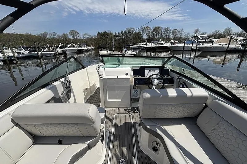 Slide: The Image of 2024 Sea Ray SDX 250 Outboard boat interior at marina, featuring luxurious seating and helm. - 5