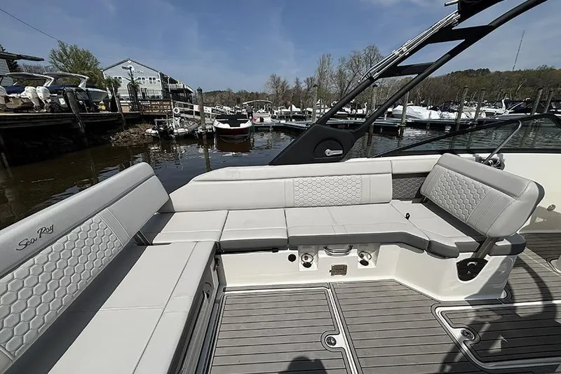 Slide: The Image of 2024 Sea Ray SDX 250 Outboard boat interior with spacious seating at a marina. - 6