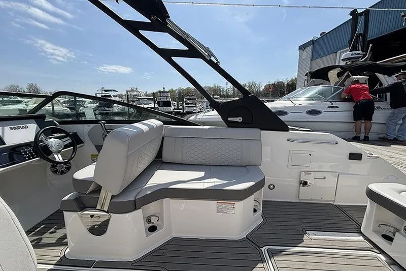 Slide: The Image of 2024 Sea Ray SDX 250 Outboard boat interior with modern seating and steering wheel. - 8