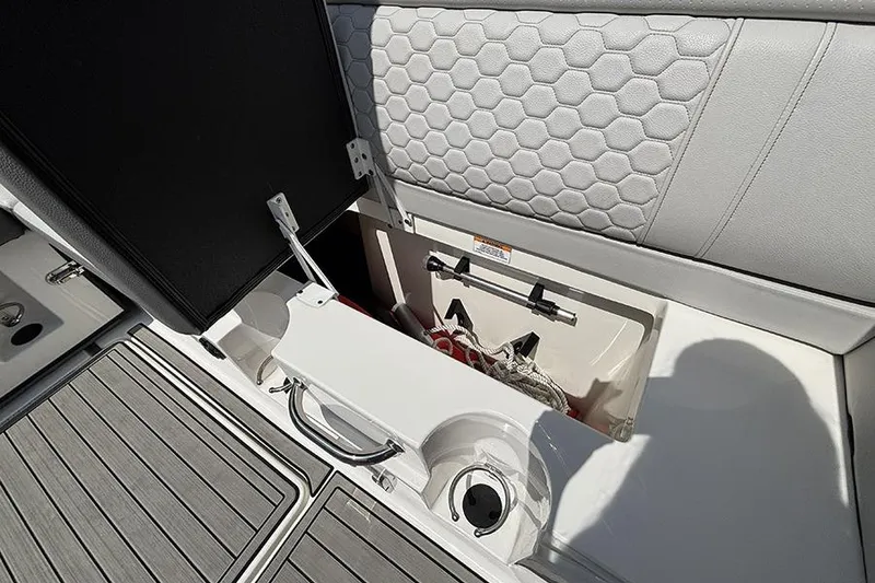 Slide: The Image of 2024 Sea Ray SDX 250 Outboard storage compartment with hexagonal upholstery design. - 9