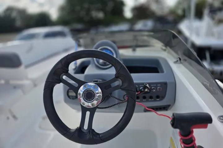Slide: The Image of Steering wheel of a 2022 Tahoe T18 boat, featuring modern dashboard controls. - 11