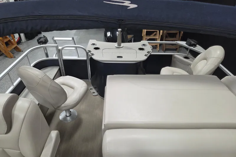 Slide: The Image of 2018 Bennington 22SFX boat interior with beige seating and a covered helm area. - 11