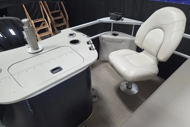 Slide: The Image of 2018 Bennington 22SFX boat interior with captain's chair and control panel. - 12
