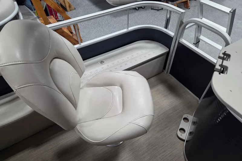Slide: The Image of 2018 Bennington 22SFX boat interior with white captain's chair and measuring ruler on deck. - 13