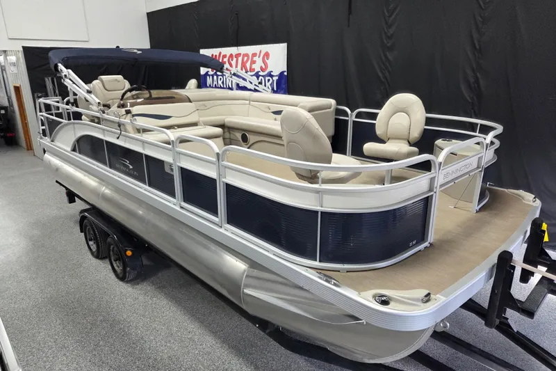 The Image of 2018 Bennington 22SFX pontoon boat with beige seating and navy accents on display. - 2