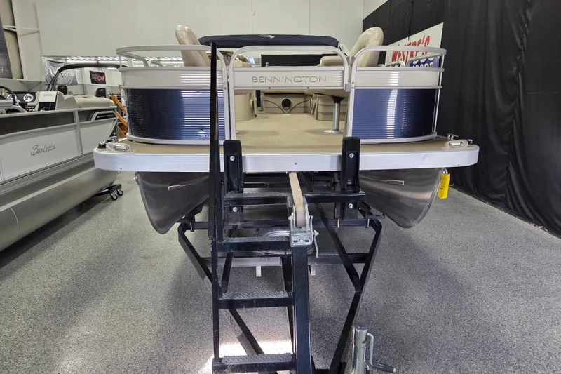 Slide: The Image of 2018 Bennington 22SFX pontoon boat displayed indoors on a lift. - 5