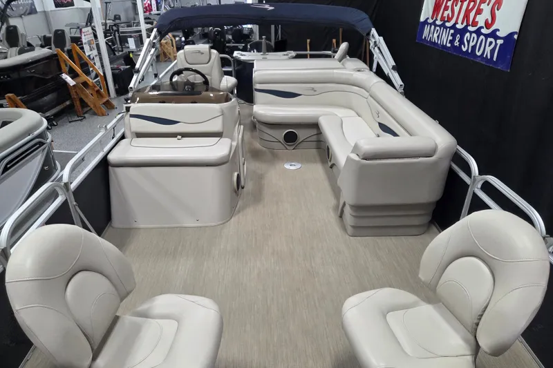 Slide: The Image of 2018 Bennington 22SFX pontoon boat interior with beige seating and helm. - 6