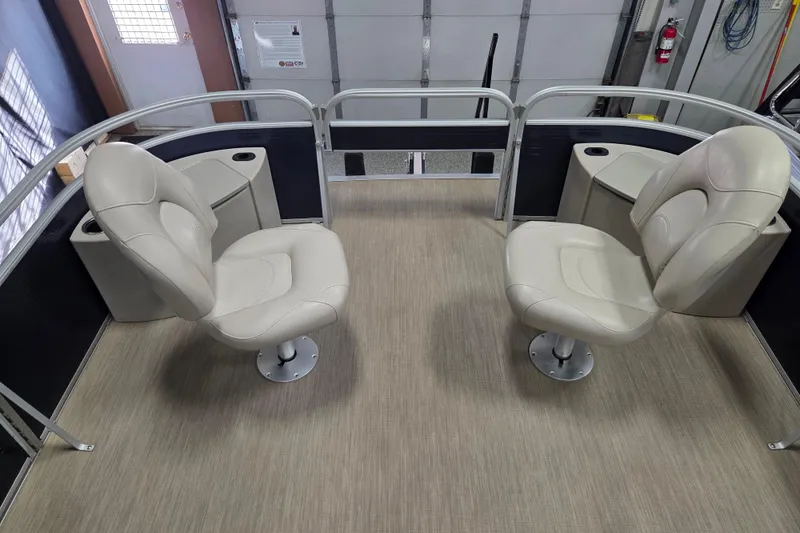 Slide: The Image of 2018 Bennington 22SFX boat interior with two beige swivel seats and cup holders. - 7