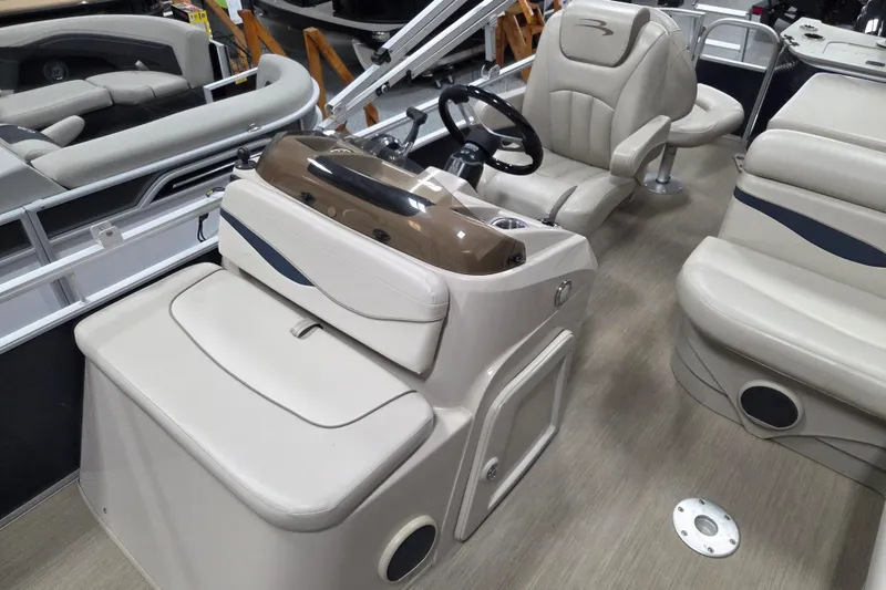 Slide: The Image of 2018 Bennington 22SFX boat interior with beige seating and steering console. - 8