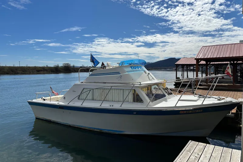 Slide: The Image of 1973 Luhrs 28 boat docked on a sunny day with clear skies. - 1