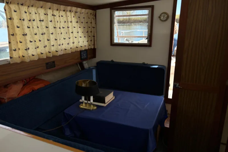 Slide: The Image of Interior of a 1973 Luhrs 28 boat with a cozy dining area. - 15