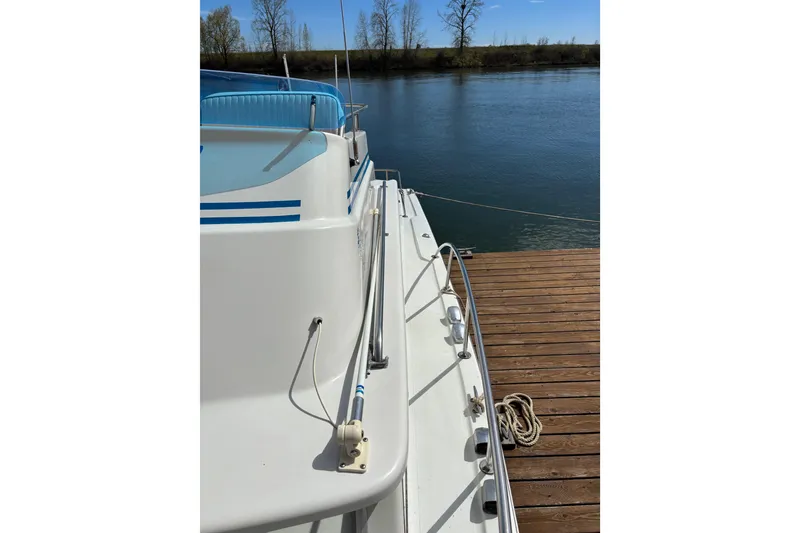 Slide: The Image of 1973 Luhrs 28 boat docked by a serene river on a sunny day. - 17