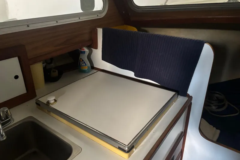 Slide: The Image of 1973 Luhrs 28 boat interior with kitchenette, sink, and storage. - 25