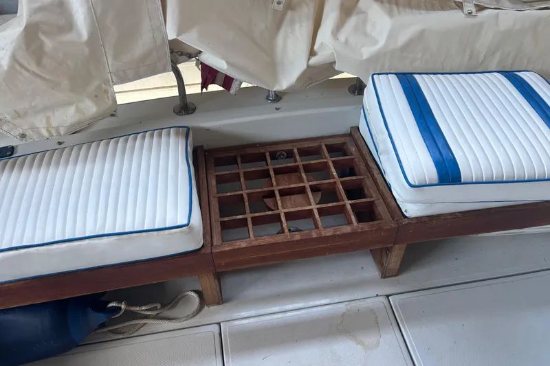 Slide: The Image of 1973 Luhrs 28 boat interior with cushioned seating and wooden flooring. - 26