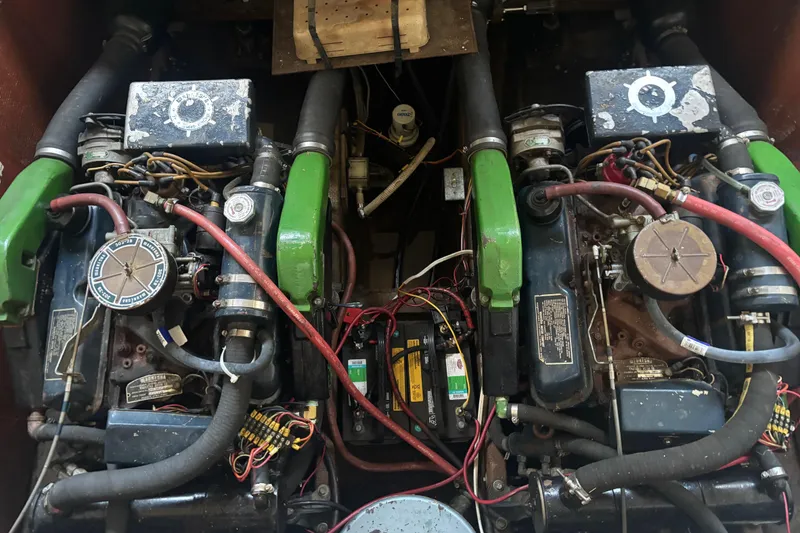 Slide: The Image of Twin engines of a 1973 Luhrs 28 boat, featuring green and black components. - 30