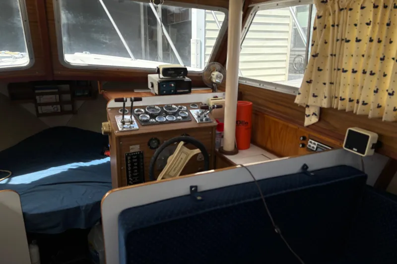 Slide: The Image of 1973 Luhrs 28 boat interior with steering wheel, gauges, and nautical decor. - 6
