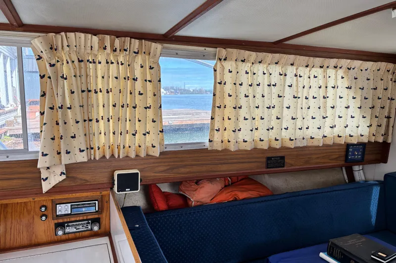 Slide: The Image of Interior of a 1973 Luhrs 28 boat with patterned curtains and vintage radio. - 8