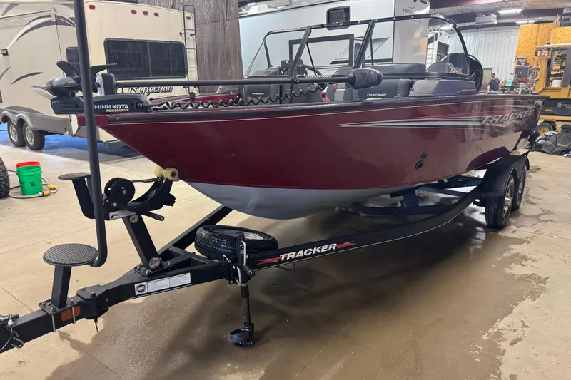 Slide: The Image of Storage compartment in 2022 Tracker Targa V-18 WT boat, featuring carpeted interior. - 13