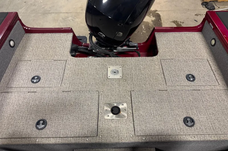 Slide: The Image of 2022 Tracker Targa V-18 WT boat deck with motor, featuring storage compartments. - 14