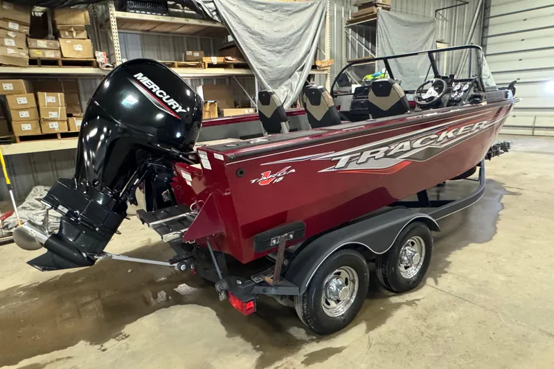 Slide: The Image of 2022 Tracker Targa V-18 WT boat with Mercury engine in a warehouse setting. - 3