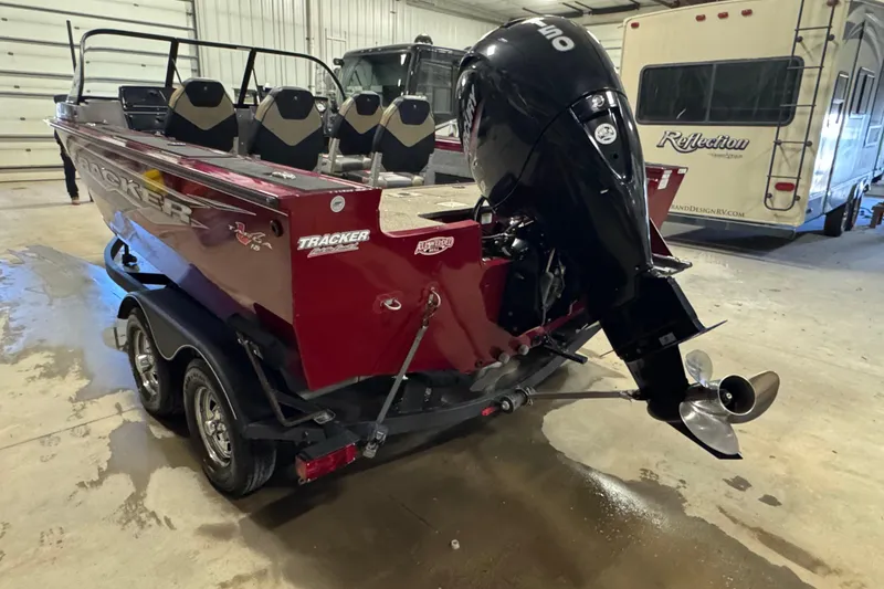 Slide: The Image of 2022 Tracker Targa V-18 WT boat with powerful outboard motor in a garage. - 4