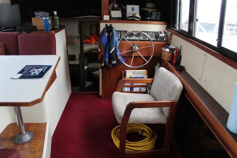 Slide: The Image of Interior of a 1985 Carver 32 Convertible boat with helm and seating area. - 10
