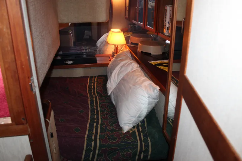 Slide: The Image of Cozy cabin interior of 1985 Carver 32 Convertible with bed and lamp. - 13