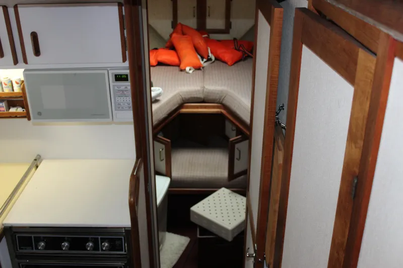 Slide: The Image of Interior of 1985 Carver 32 Convertible boat with kitchen and sleeping area. - 14