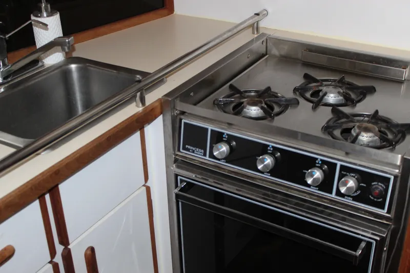 Slide: The Image of Compact kitchen in 1985 Carver 32 Convertible with stove and sink. - 17