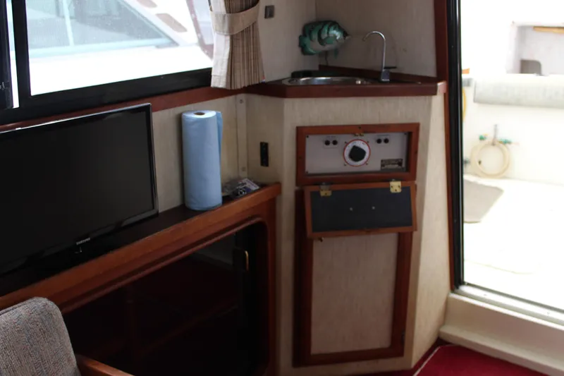 Slide: The Image of Interior of 1985 Carver 32 Convertible with TV, sink, and control panel. - 21