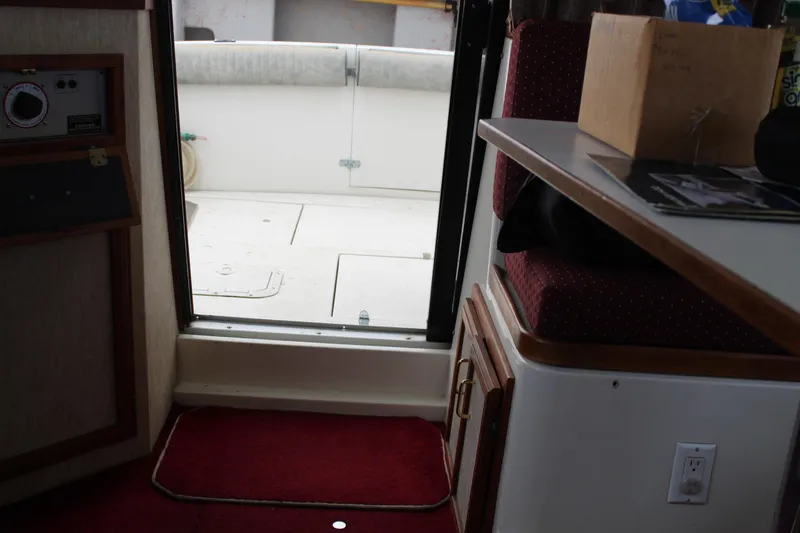 Slide: The Image of Interior view of 1985 Carver 32 Convertible boat, showing cabin entrance and seating area. - 22