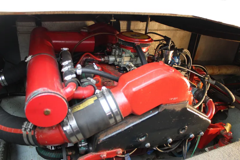 Slide: The Image of Engine compartment of a 1985 Carver 32 Convertible boat, featuring red components. - 24