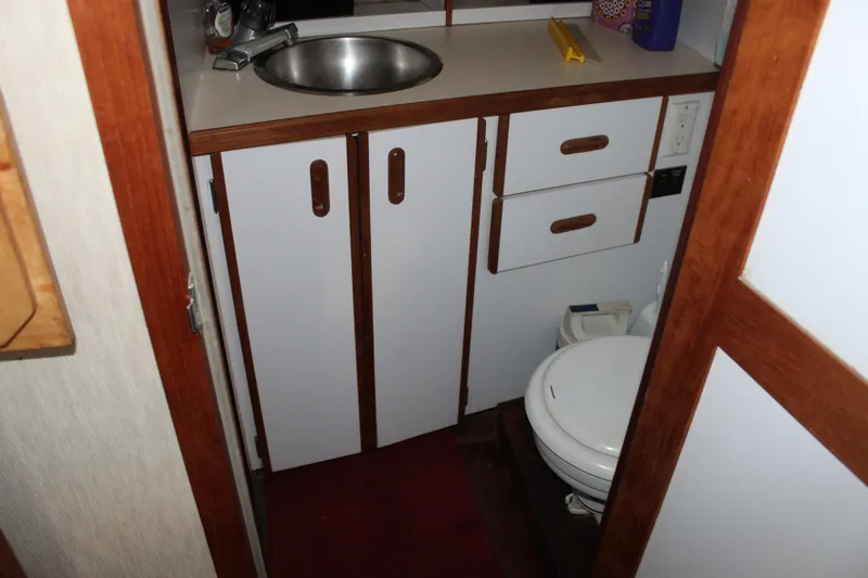 Slide: The Image of 1985 Carver 32 Convertible bathroom with sink, cabinets, and toilet. - 34