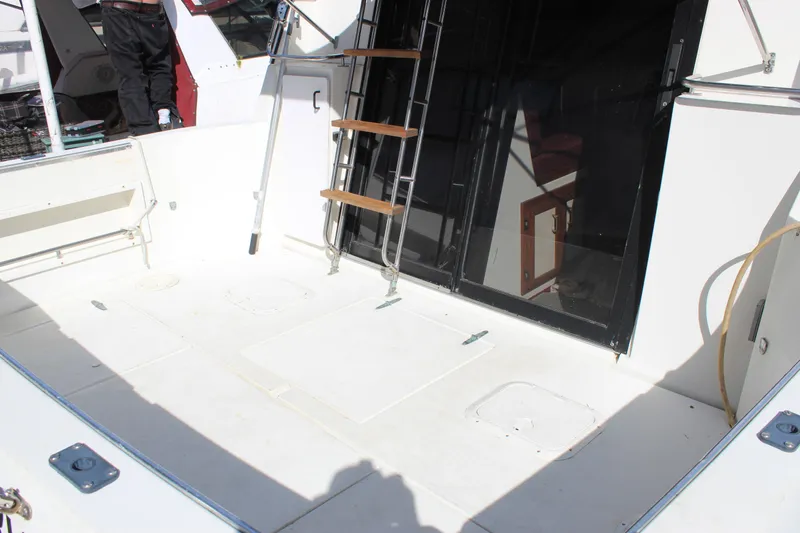 Slide: The Image of 1985 Carver 32 Convertible boat deck with ladder and cabin entrance. - 4